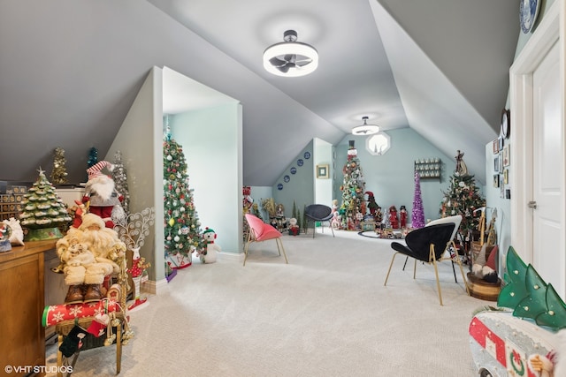 recreation room featuring vaulted ceiling and carpet flooring