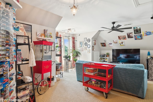 living room featuring ceiling fan, vaulted ceiling, and carpet flooring