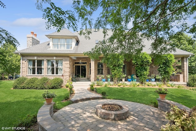 view of front facade with an outdoor fire pit, a patio, and a front yard