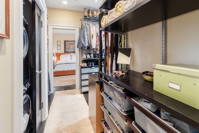 walk in closet featuring stacked washer / dryer