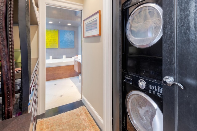 clothes washing area with stacked washer / drying machine