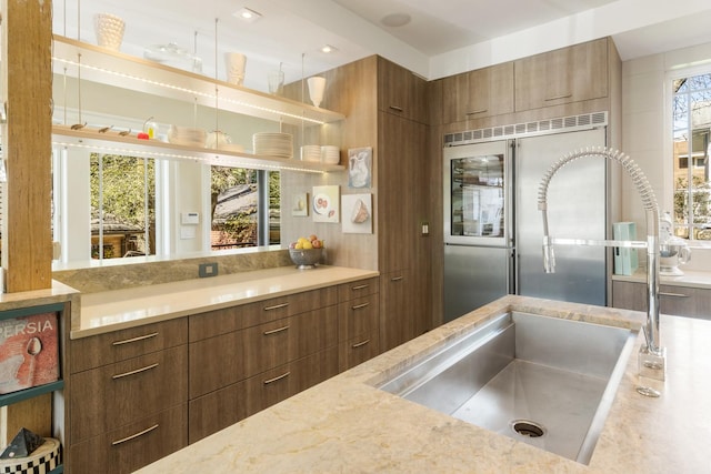 interior space with light stone counters and built in refrigerator