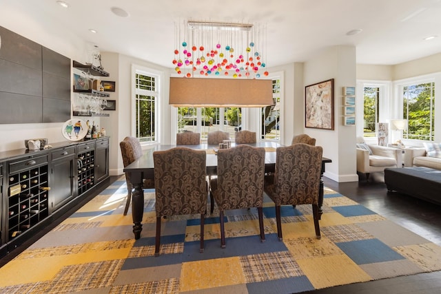 dining space featuring a healthy amount of sunlight and dark hardwood / wood-style floors