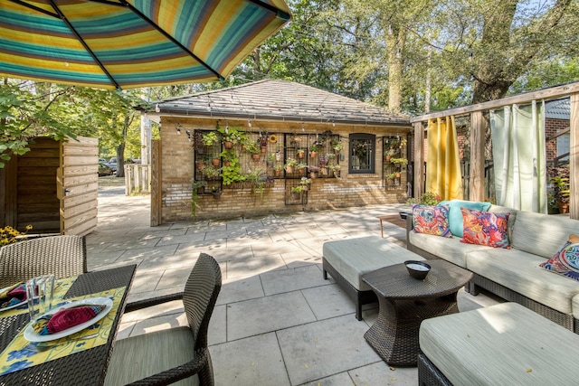 view of patio / terrace featuring an outbuilding and outdoor lounge area