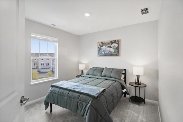 carpeted bedroom featuring multiple windows