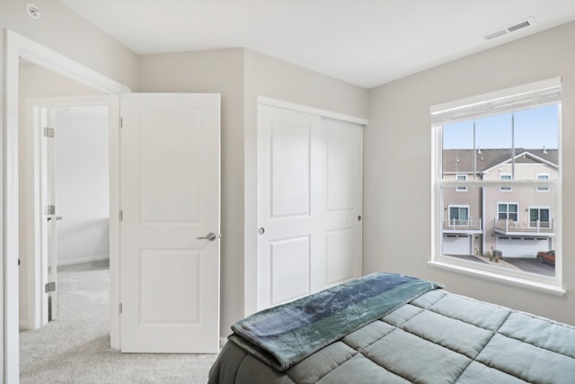 carpeted bedroom featuring a closet