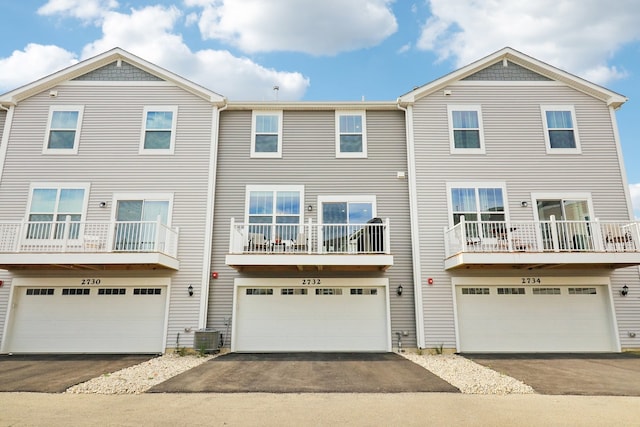 multi unit property featuring central AC, a balcony, and a garage