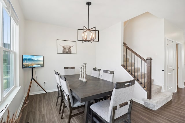 dining area featuring a chandelier and dark hardwood / wood-style flooring