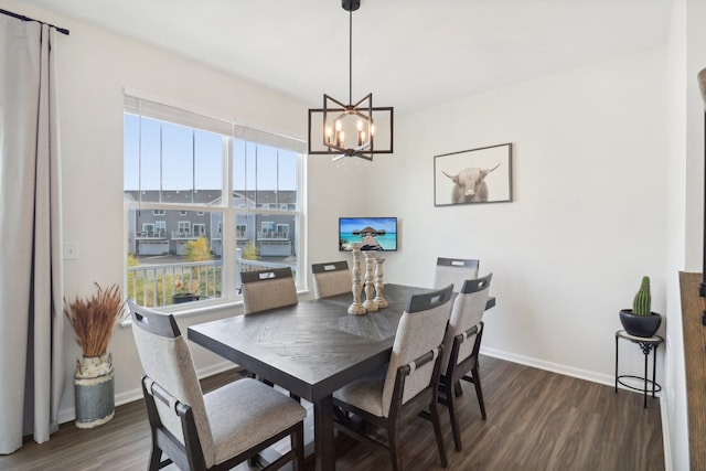 dining room featuring dark hardwood / wood-style flooring, an inviting chandelier, and plenty of natural light