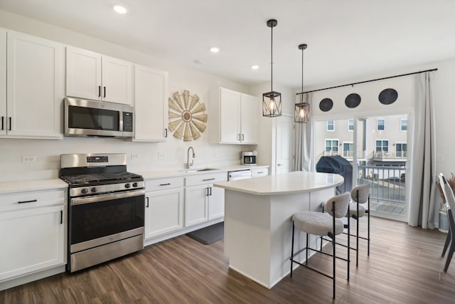 kitchen with white cabinetry, stainless steel appliances, sink, and dark hardwood / wood-style flooring