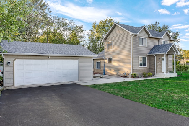 view of front property with a front yard and a garage