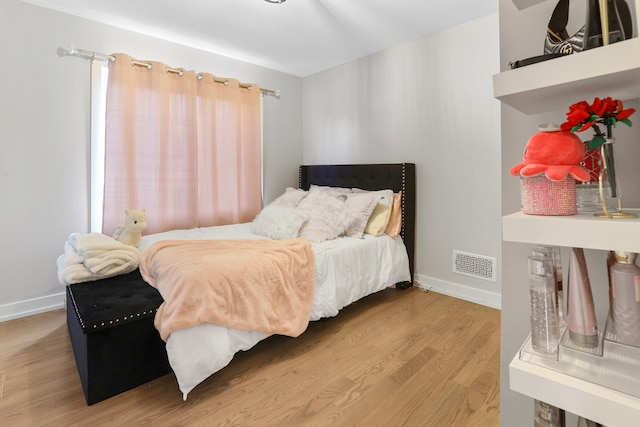 bedroom with hardwood / wood-style flooring