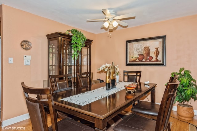 dining space featuring hardwood / wood-style flooring and ceiling fan