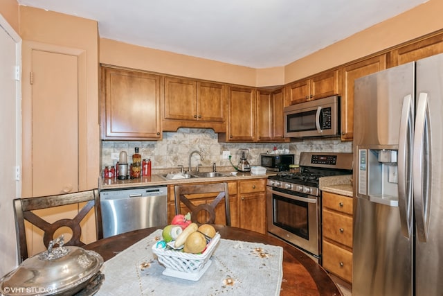 kitchen with dark hardwood / wood-style flooring, stainless steel appliances, sink, and tasteful backsplash