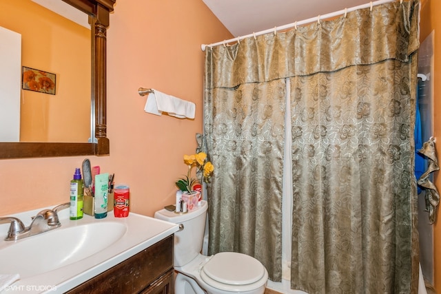 bathroom with curtained shower, vanity, and toilet