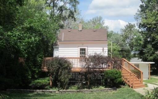 back of house featuring a wooden deck