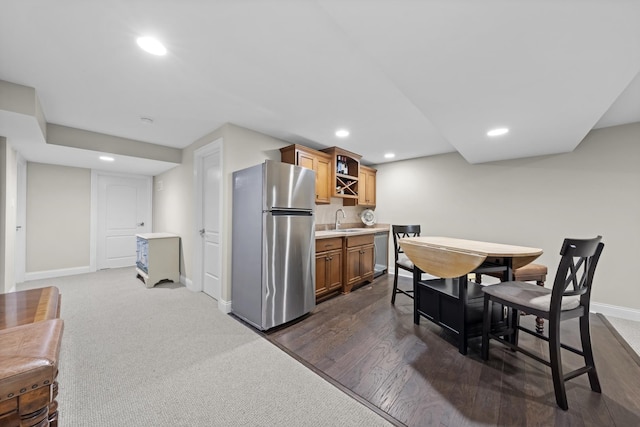 kitchen featuring dark wood-type flooring, stainless steel appliances, and sink