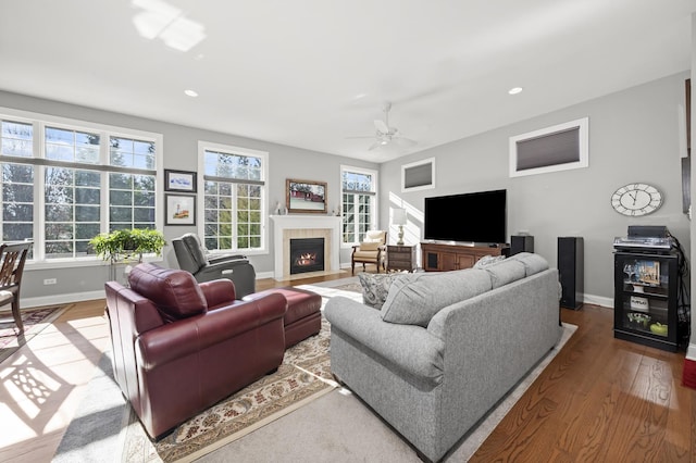 living room featuring ceiling fan and hardwood / wood-style floors