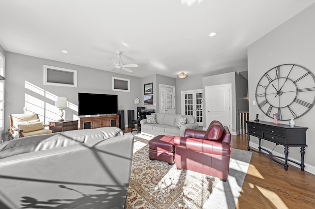 living room with wood-type flooring and ceiling fan