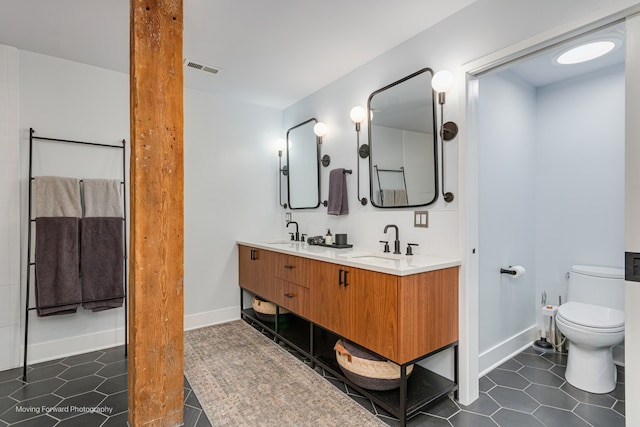 bathroom with vanity, tile patterned flooring, and toilet