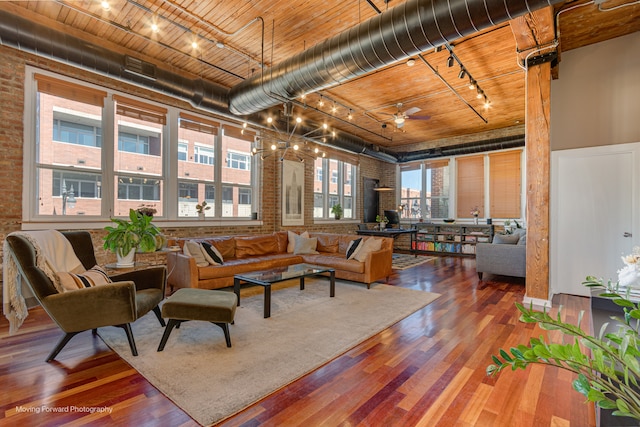 interior space featuring brick wall, hardwood / wood-style flooring, wood ceiling, and ceiling fan