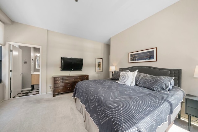 bedroom featuring light carpet and ensuite bathroom