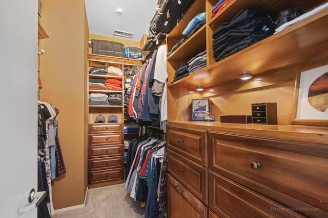 walk in closet featuring light colored carpet