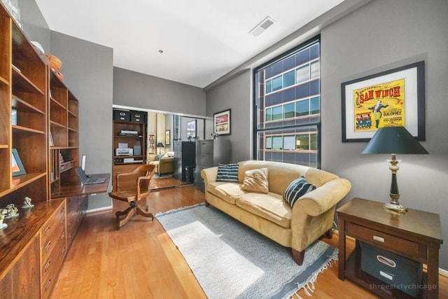 sitting room with wood-type flooring