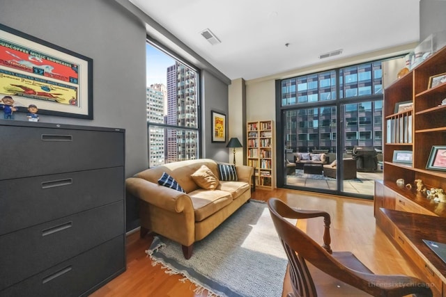 living area featuring floor to ceiling windows and hardwood / wood-style floors