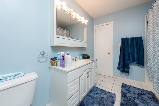 bathroom with vanity, toilet, and tile patterned floors