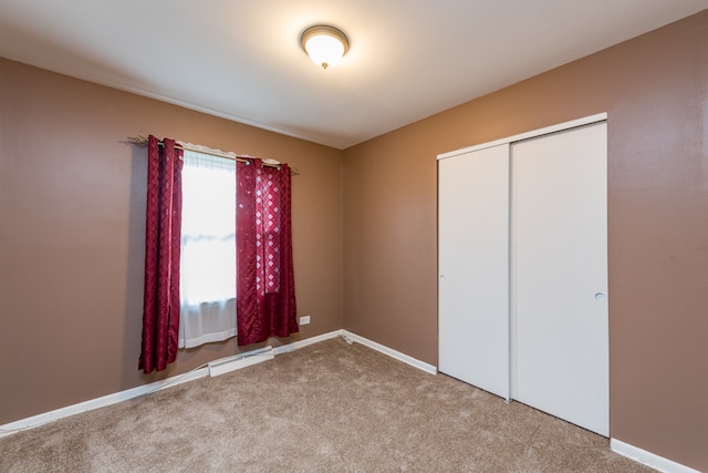 unfurnished bedroom featuring a closet and carpet flooring