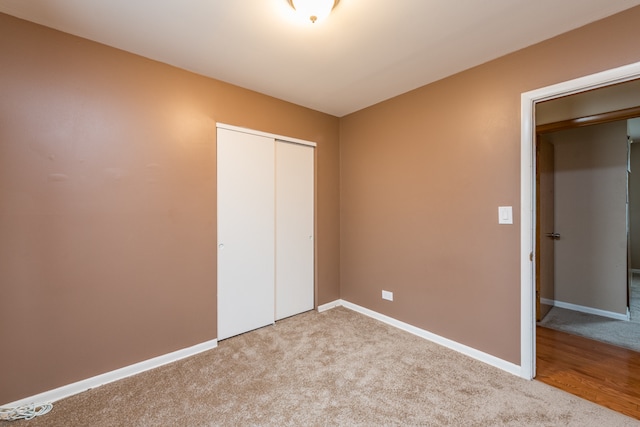 unfurnished bedroom with a closet and carpet