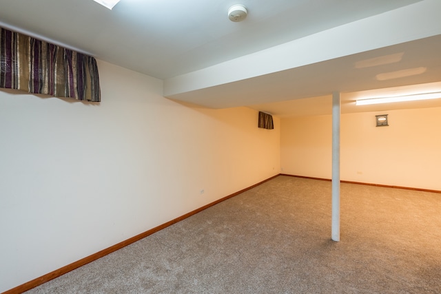 basement featuring light carpet