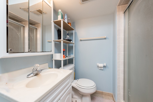 bathroom with a shower with door, toilet, tile patterned floors, and vanity