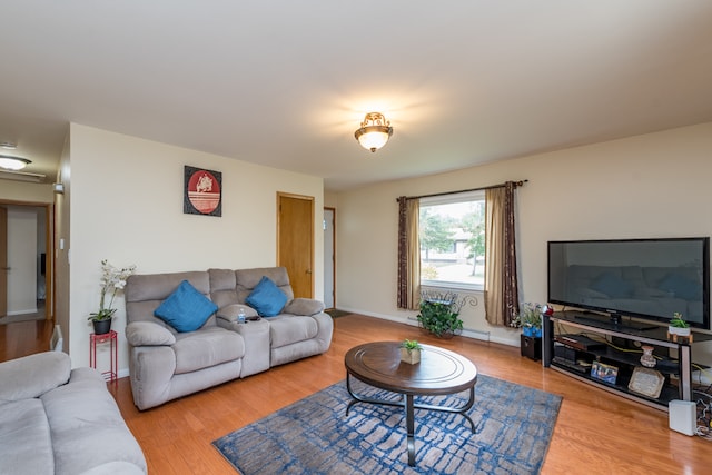 living room with baseboard heating and hardwood / wood-style floors