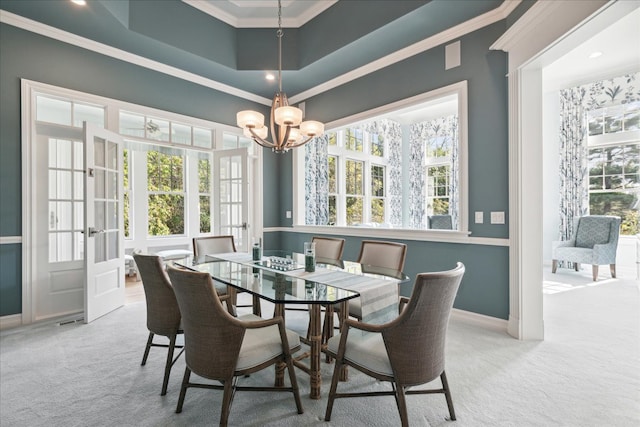 dining area with light carpet, ornamental molding, and a healthy amount of sunlight