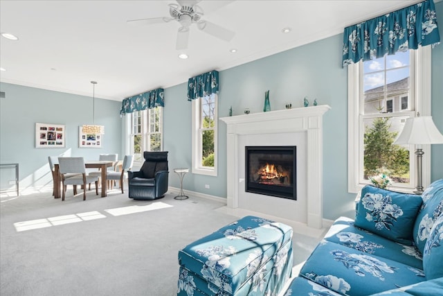 living room with ornamental molding, light carpet, and ceiling fan