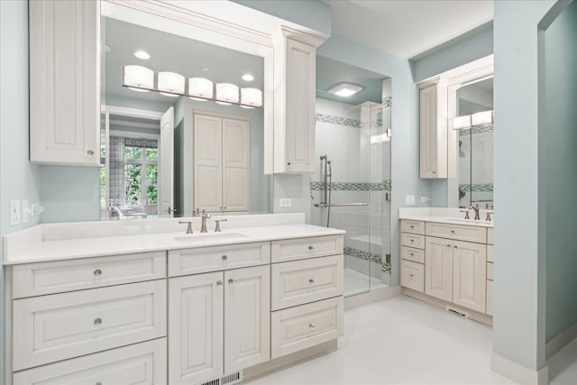 bathroom featuring vanity and a shower with shower door