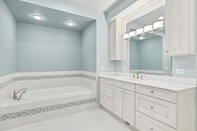 bathroom with vanity and tiled tub