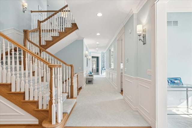 hall featuring ornamental molding and light carpet