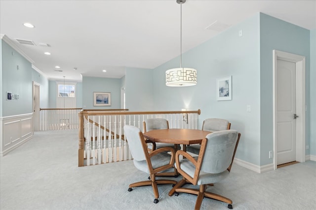 carpeted dining space featuring ornamental molding