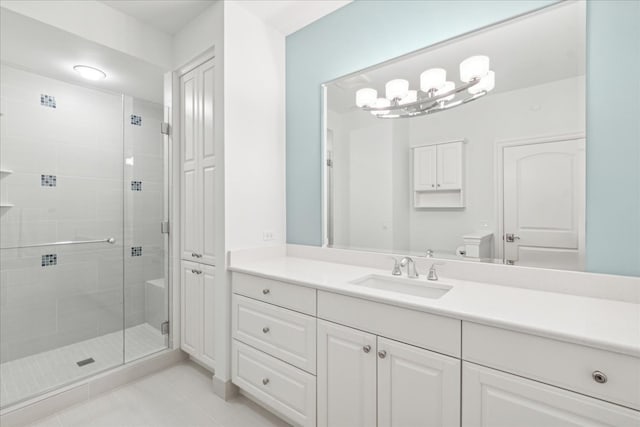 bathroom with a shower with door, vanity, a chandelier, and toilet