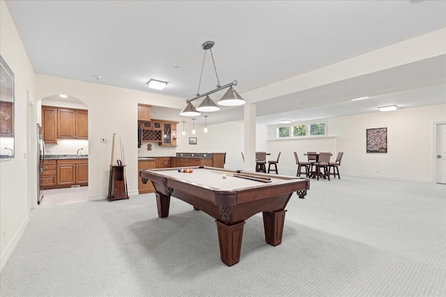 playroom featuring indoor wet bar, pool table, and light colored carpet