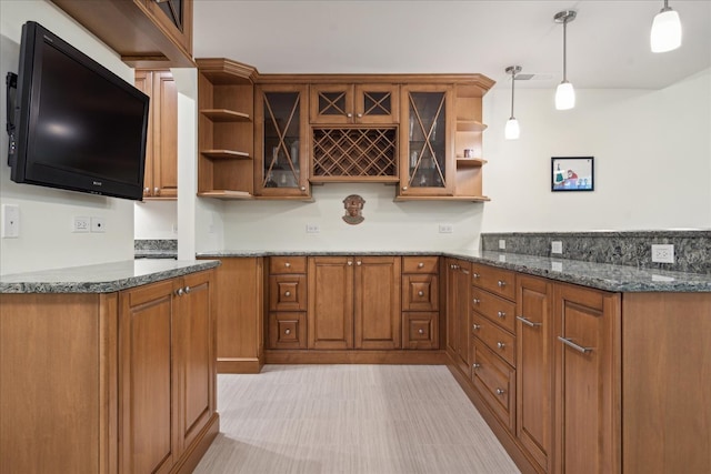 kitchen with dark stone countertops and hanging light fixtures