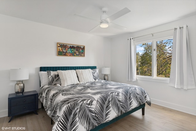 bedroom with ceiling fan and light hardwood / wood-style flooring