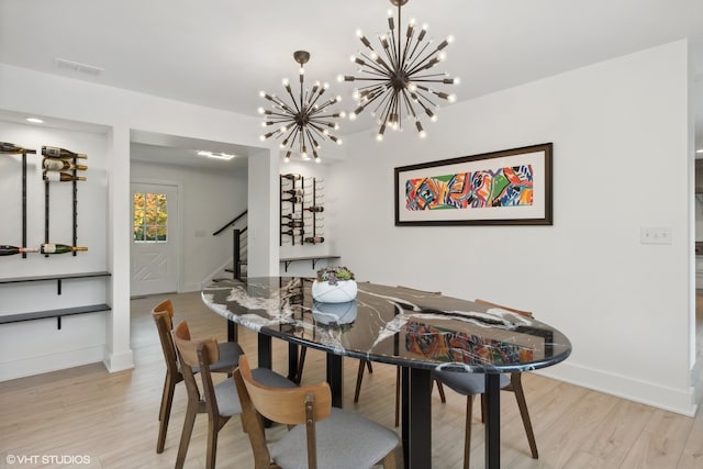 dining room featuring a chandelier and light wood-type flooring