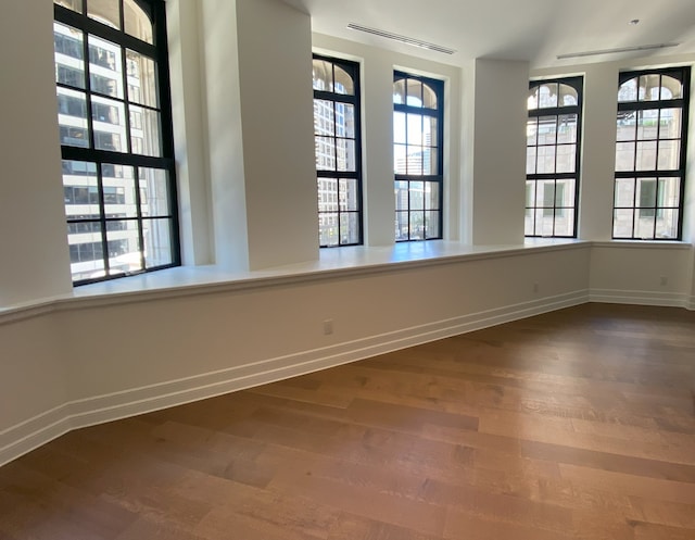 unfurnished room with wood-type flooring