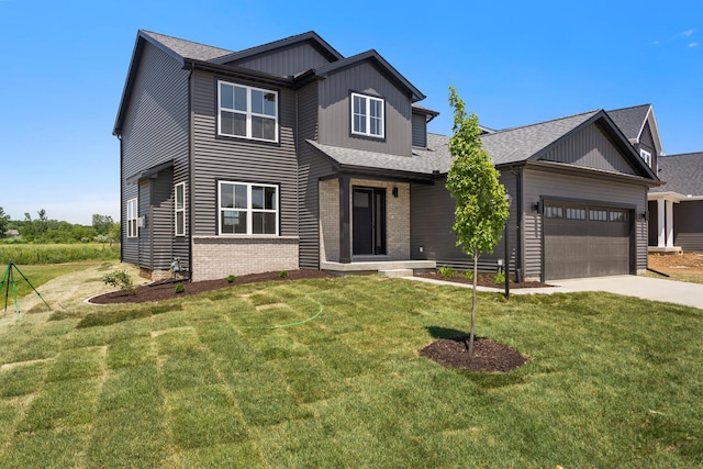 view of front of property with a front lawn and a garage