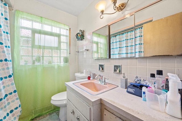 bathroom with backsplash, vanity, curtained shower, and toilet