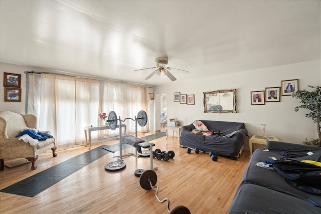 exercise area with light wood-type flooring and ceiling fan